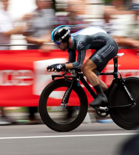 Dynamic shot of a cyclist competing in a fast-paced cycling event, showcasing speed and athleticism.